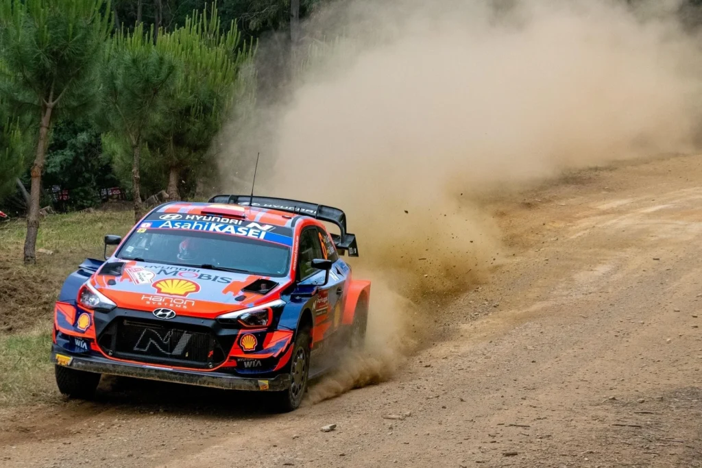 Hyundai WRC rally car launching off gravel terrain